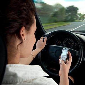 woman texting while driving