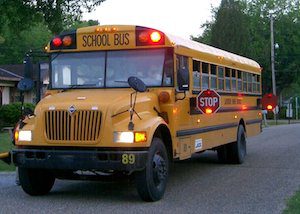Economics may play a larger role in the sudden rise in illegal school bus passing. Photo courtesy Wikimedia Commons.