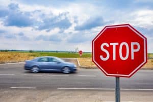 car speeding past stop sign