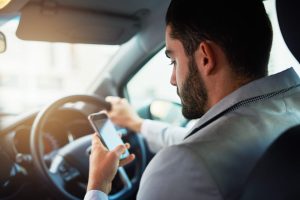 man texting while he is driving
