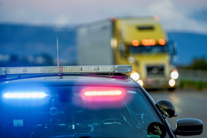 an american semi-truck being pulled over by state police