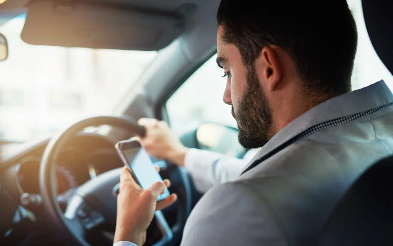 man texting while he is driving