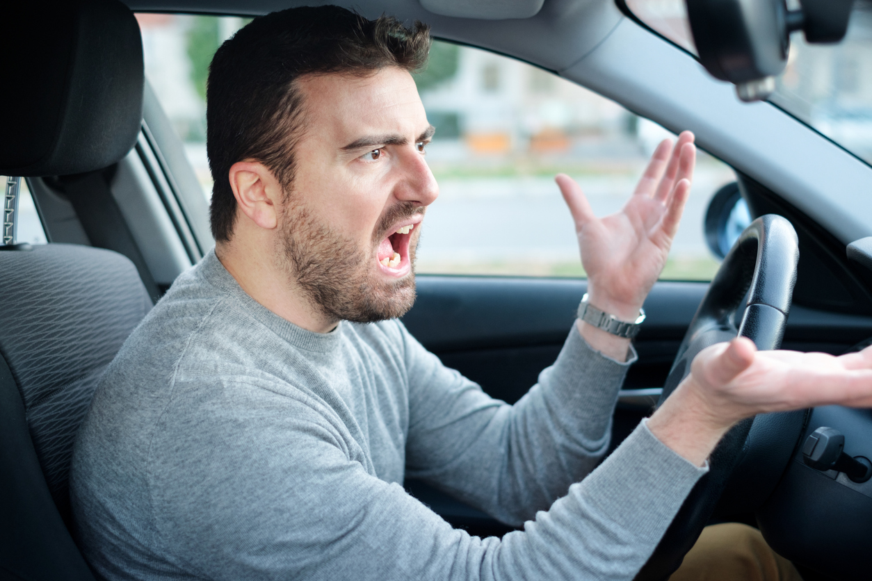 Angry and rude driver portrait sitting in his car