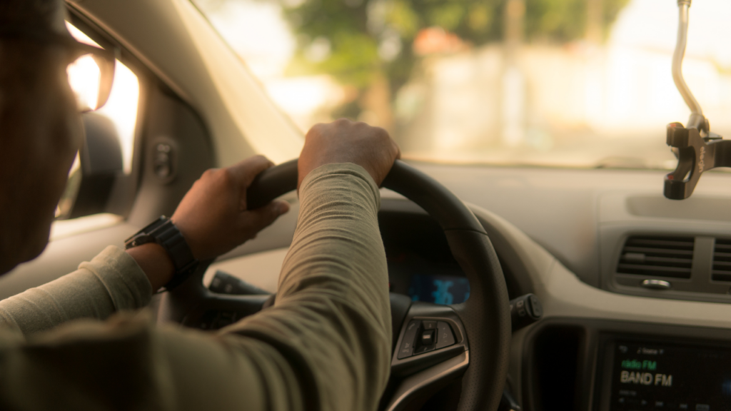 A person driving a vehicle on the road.