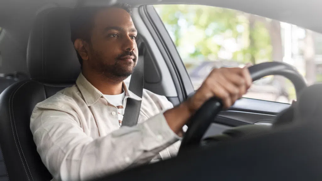 A man driving a car in New York.