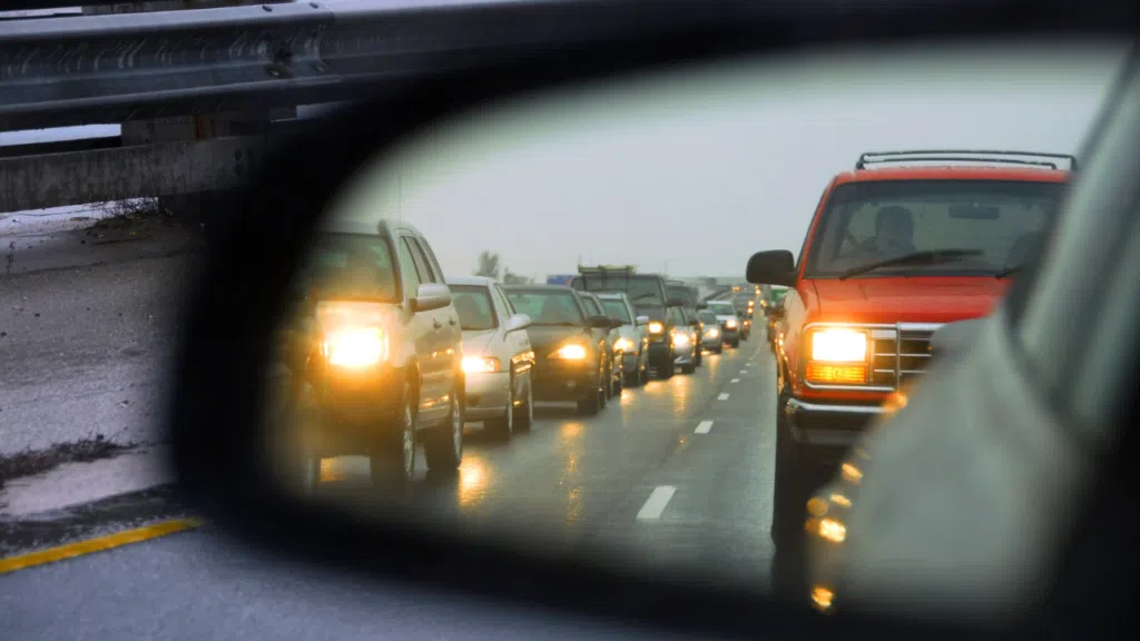 A car side mirror showing New York traffic.